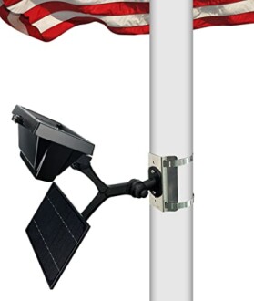 Solar panel and light attached to a flagpole with a waving American flag.