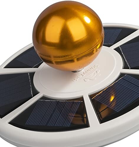 Solar pool cleaner with golden ball and solar panels.